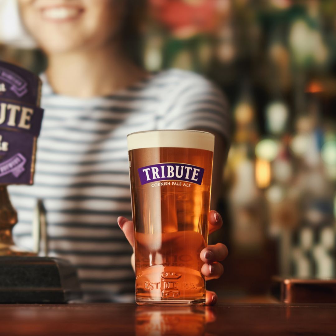 A pint of Tribute Pale Ale is pushed across the bar towards you